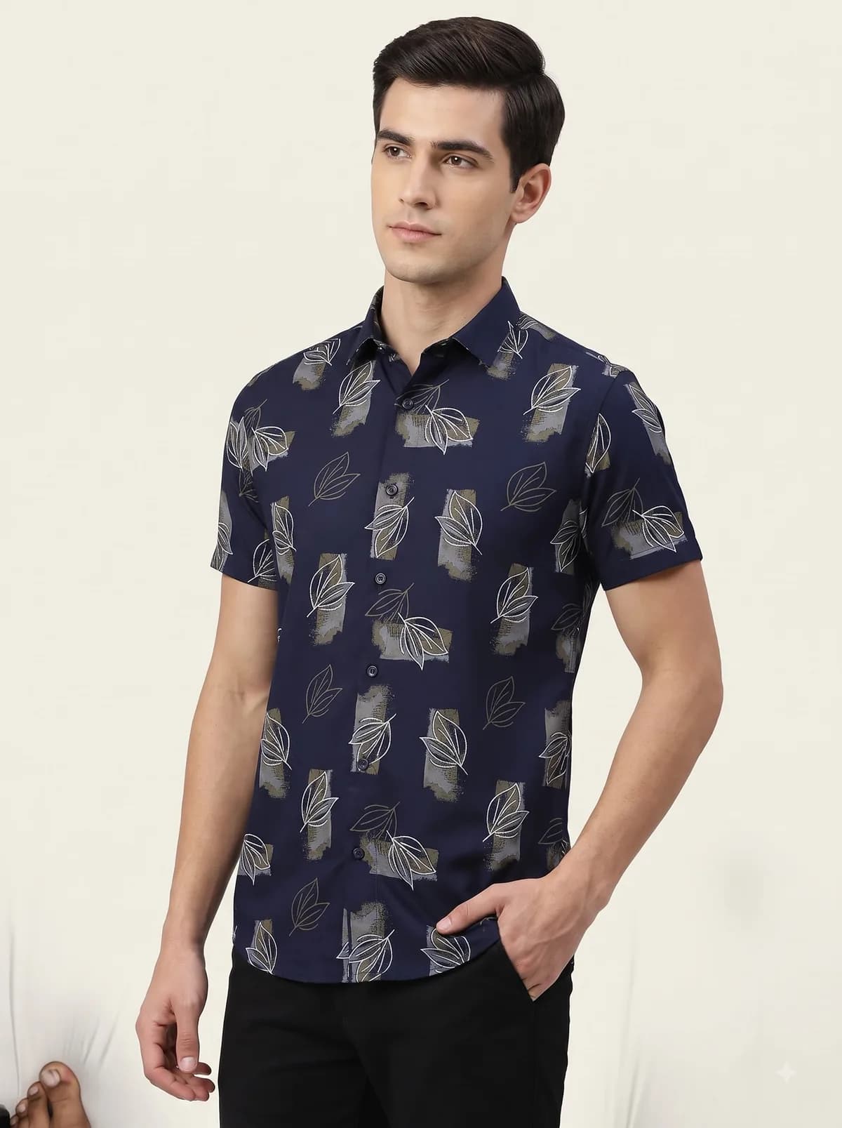 Model in a navy half-sleeve shirt with a white leaf outline and brush-block print